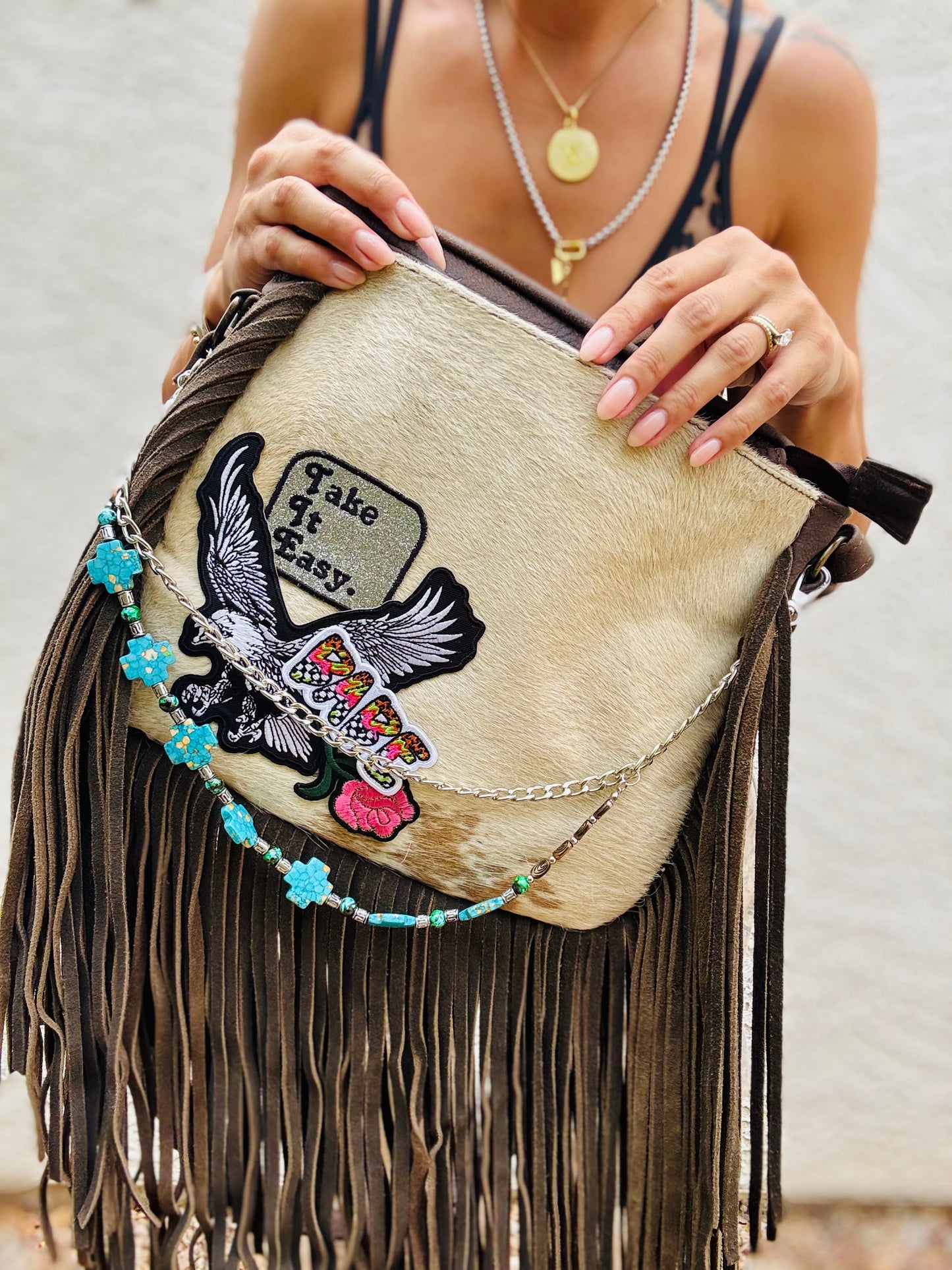 AUGBAG- GENUINE COWHIDE HAIR ON CROSSBODY FRINGE BAG- REAL AUTHENTIC WITH EAGLE TAKE IT EASY VIBES AND HANDBEADED CHAIN WORK.