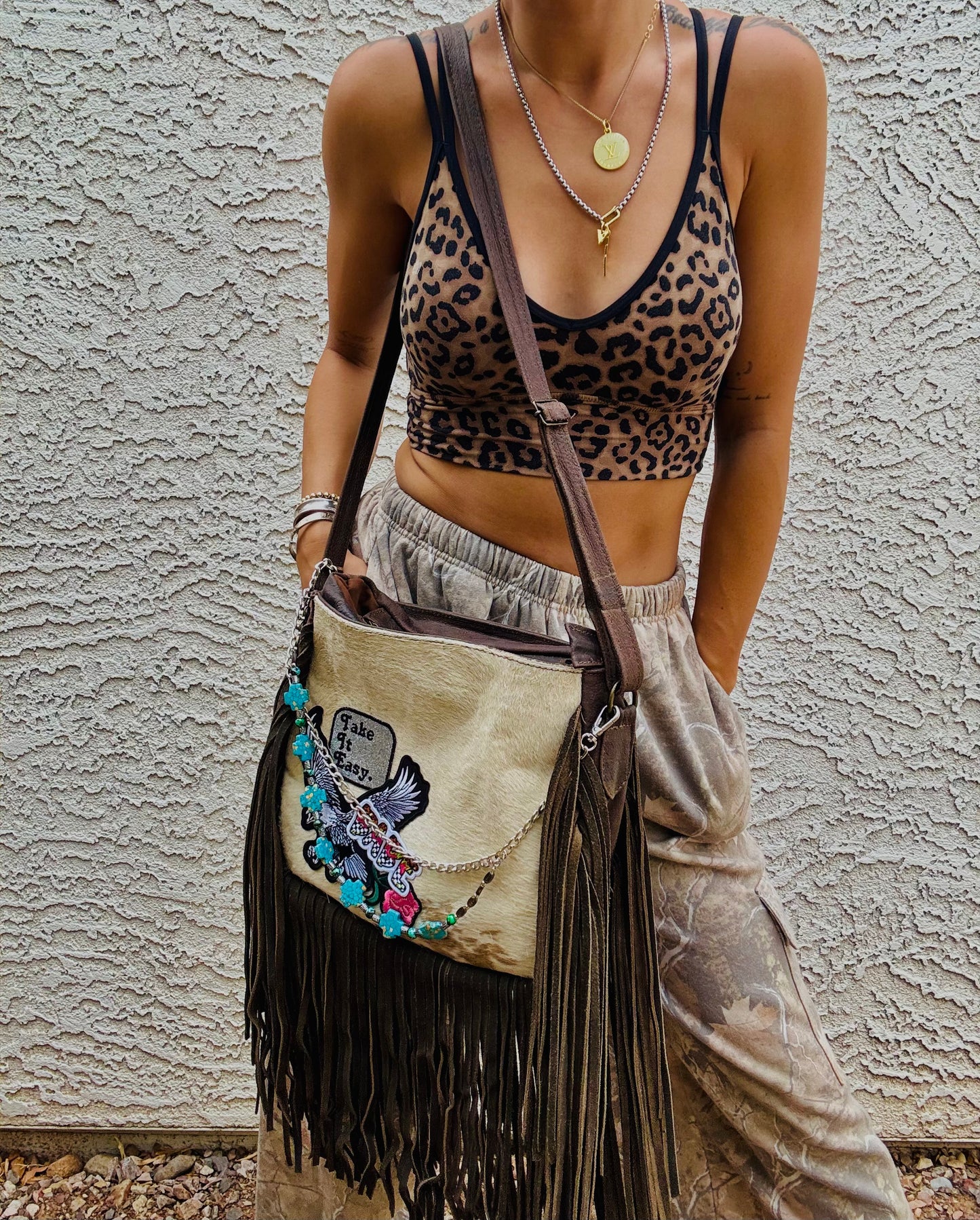AUGBAG- GENUINE COWHIDE HAIR ON CROSSBODY FRINGE BAG- REAL AUTHENTIC WITH EAGLE TAKE IT EASY VIBES AND HANDBEADED CHAIN WORK.