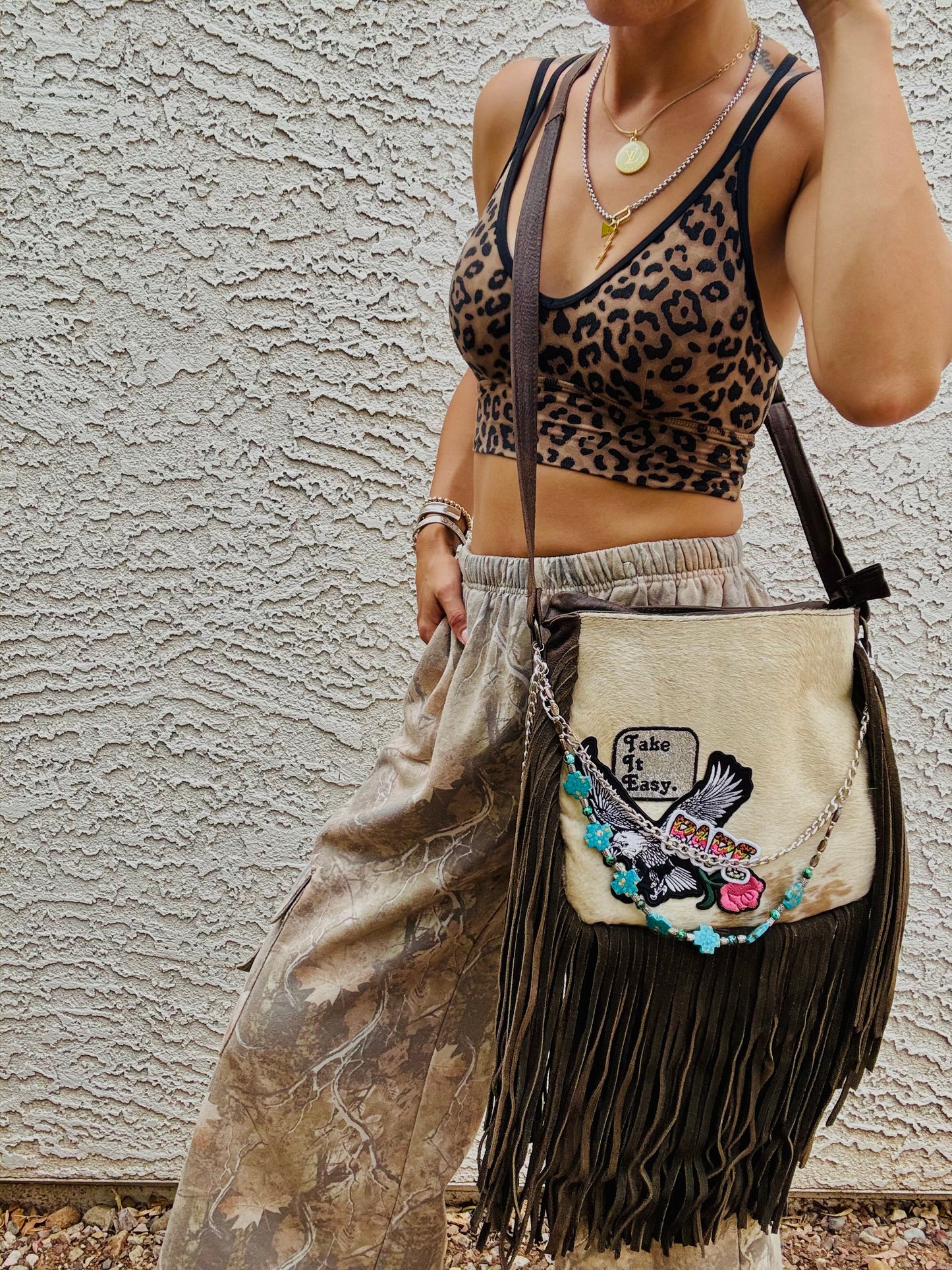 AUGBAG- GENUINE COWHIDE HAIR ON CROSSBODY FRINGE BAG- REAL AUTHENTIC WITH EAGLE TAKE IT EASY VIBES AND HANDBEADED CHAIN WORK.