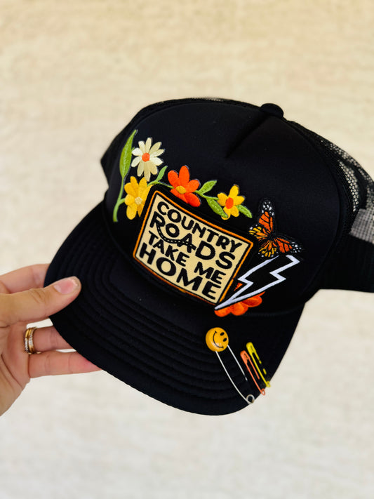 CM CO. Neon orange country roads black Trucker